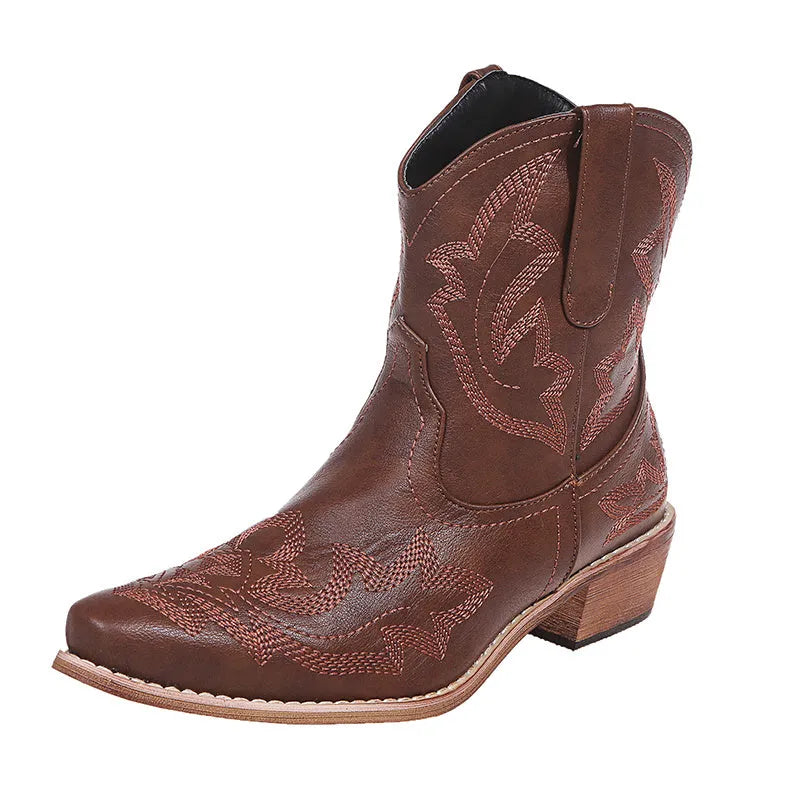 Women's blue embroidered cowboy ankle boots with a low wedge heel and pointed toe.