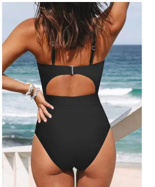 Solid colour women's one-piece swimsuit with cross-back design on mannequin.