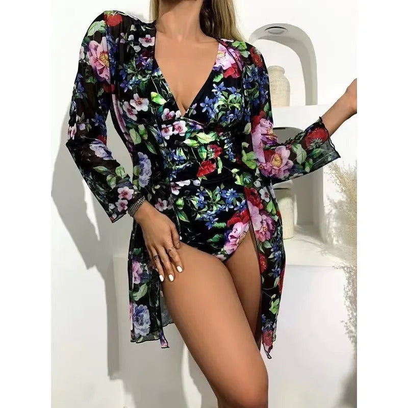 Women's floral patterned tight bikini three-piece swimsuit set with a cover-up coat.