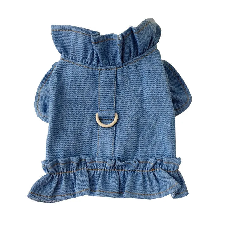Blue denim dog dress with ruffles and a chest harness leash hook on a mannequin.