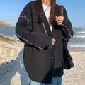 Women's loose fit knitted cardigan coat in black or white polyester with long sleeves