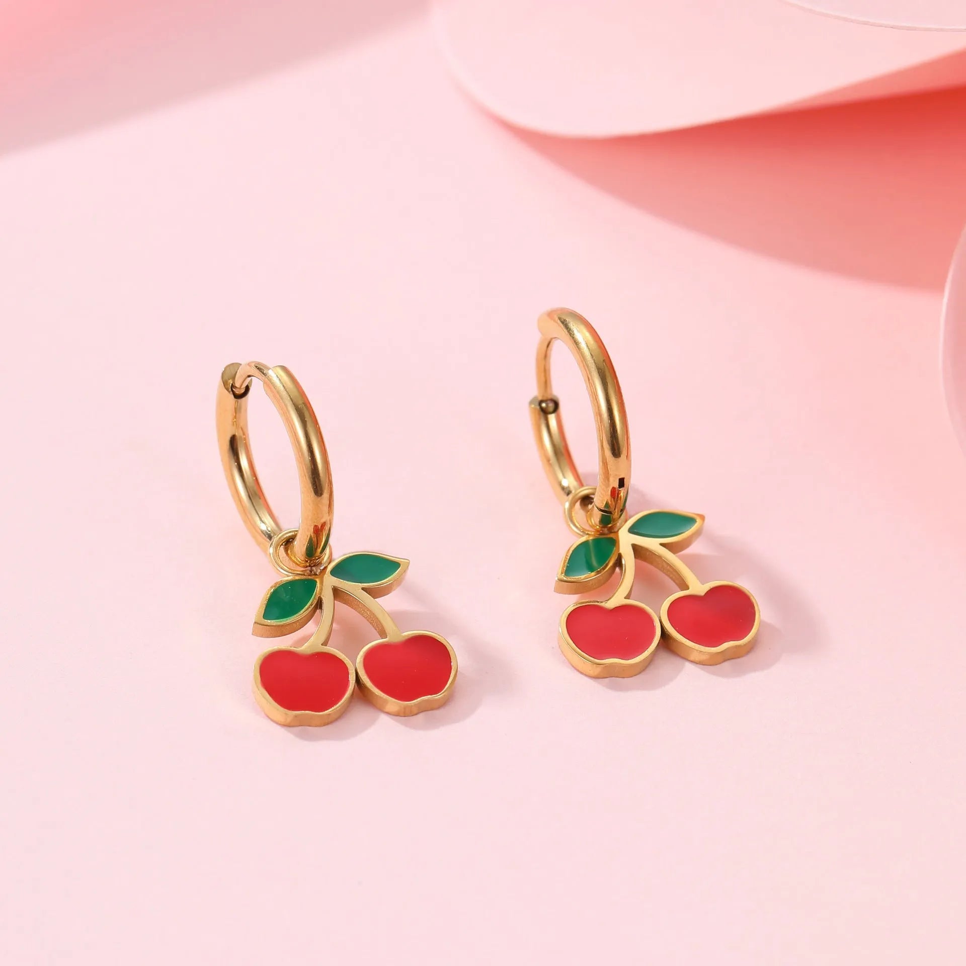 Cherry jewellery set showing necklace, bracelet, earrings, and ring with stainless steel construction and cherry motifs