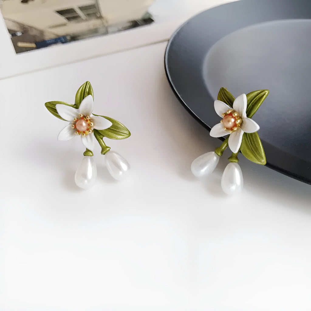 Women's alloy earrings set showing flower studs and camellia ear clip in contrasting colours