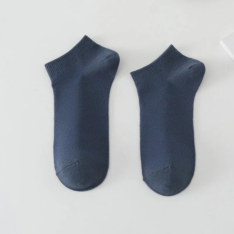 Pair of solid colour low-cut boat socks for men made from breathable polyester.