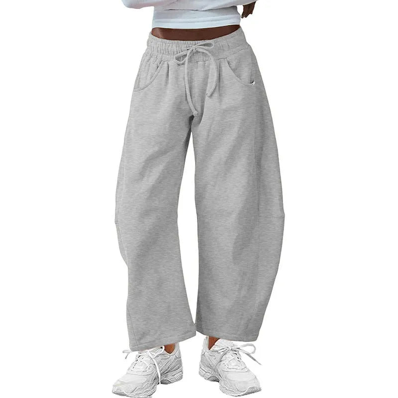 Women's loose cropped sweatpants with elastic waist and drawstring pockets in street fashion style