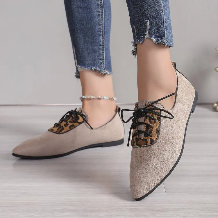 Beige leopard print women's pointed toe high heel pumps with a rubber sole.