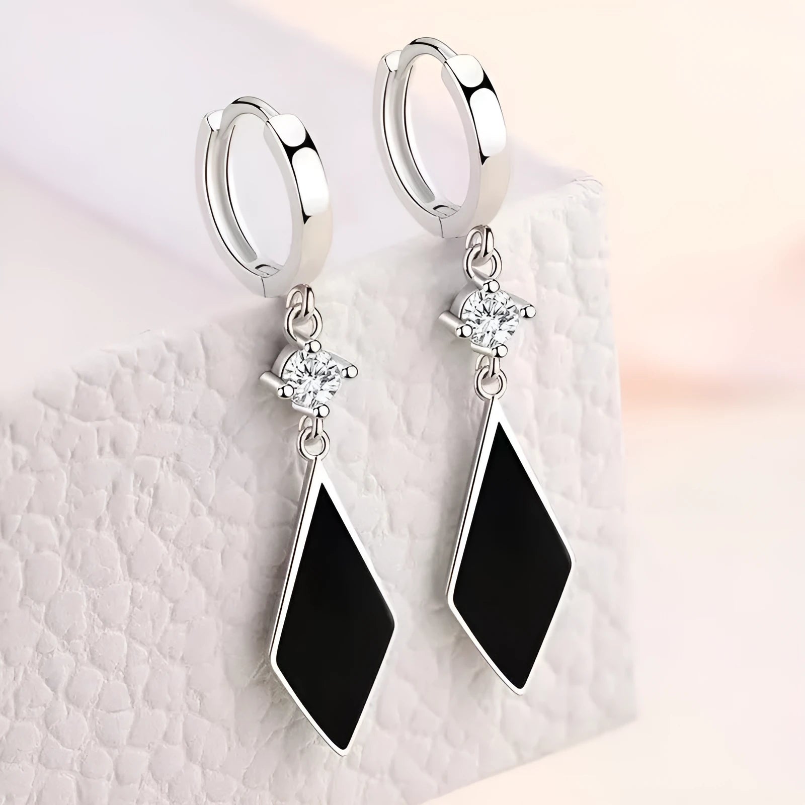 Silver geometric diamond-shaped clip-on fashion earrings with a vintage diamond finish.