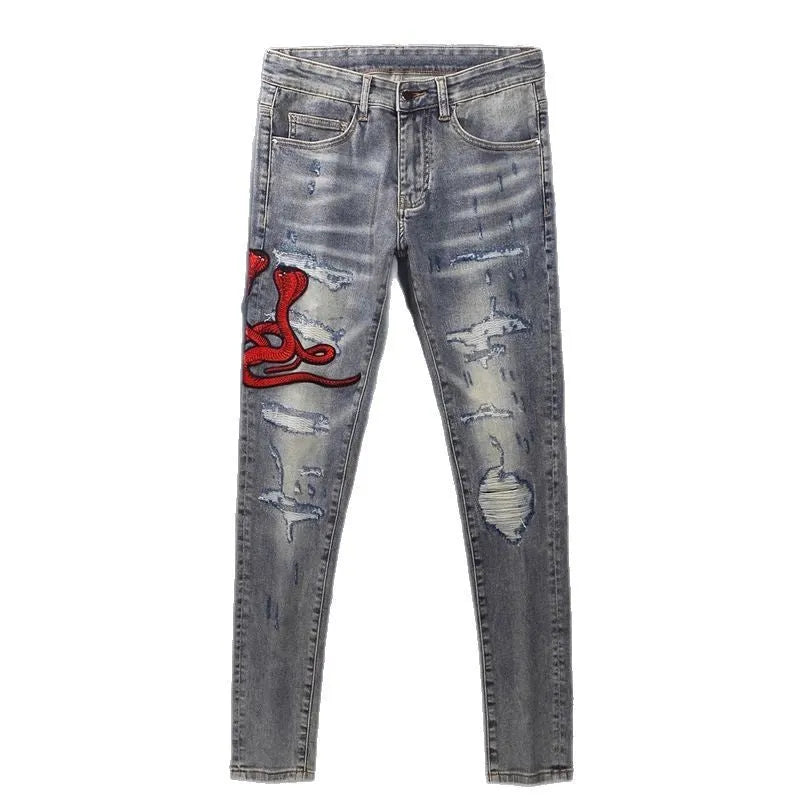 Men's slim fit jeans in old colour with a worn look, hole patches, and embroidered details on a mid-waist design.