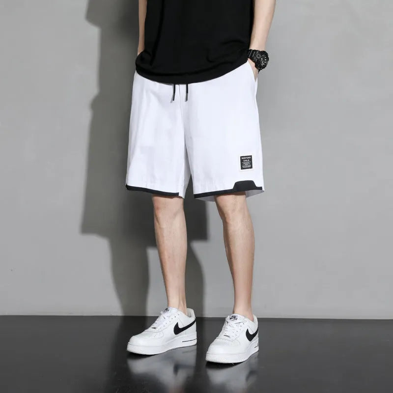 Boys' black cotton shorts in a plus size on a hanger