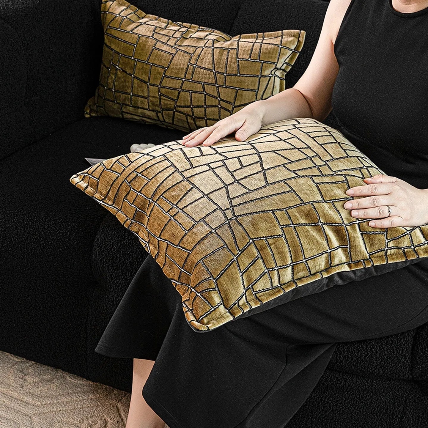Gold geometric pattern decorative cushion cover on a grey sofa
