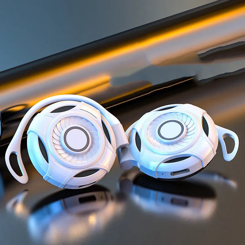 Black and white wireless gaming earphones with hanging ear design and USB charging cable