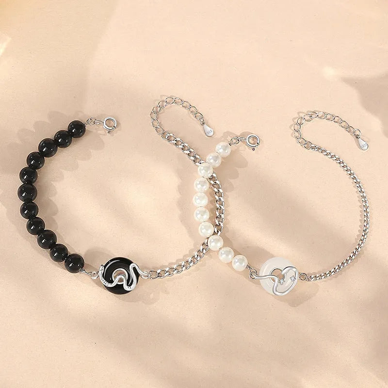 A pair of 925 sterling silver bracelets for men and women featuring a snake zodiac charm and a safety buckle clasp.