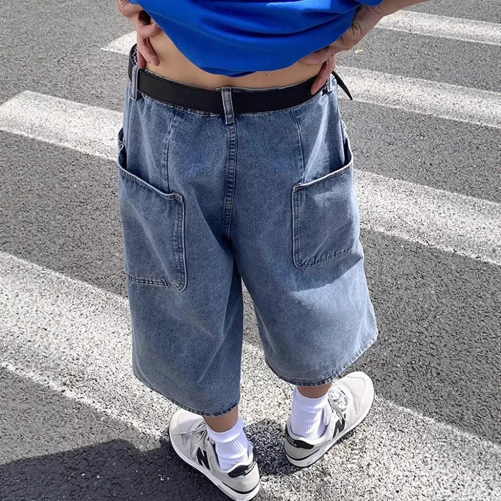 Men's washed light blue denim cropped shorts with a high waist and zipper fly.