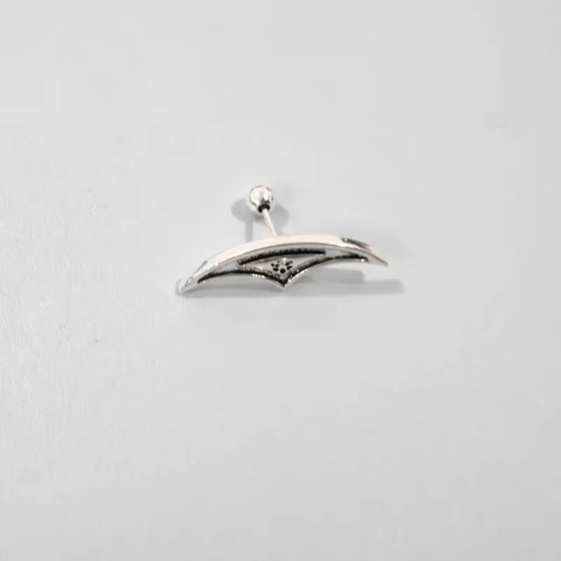 Geometric spider web stud earrings in gold and silver electroplated metal.
