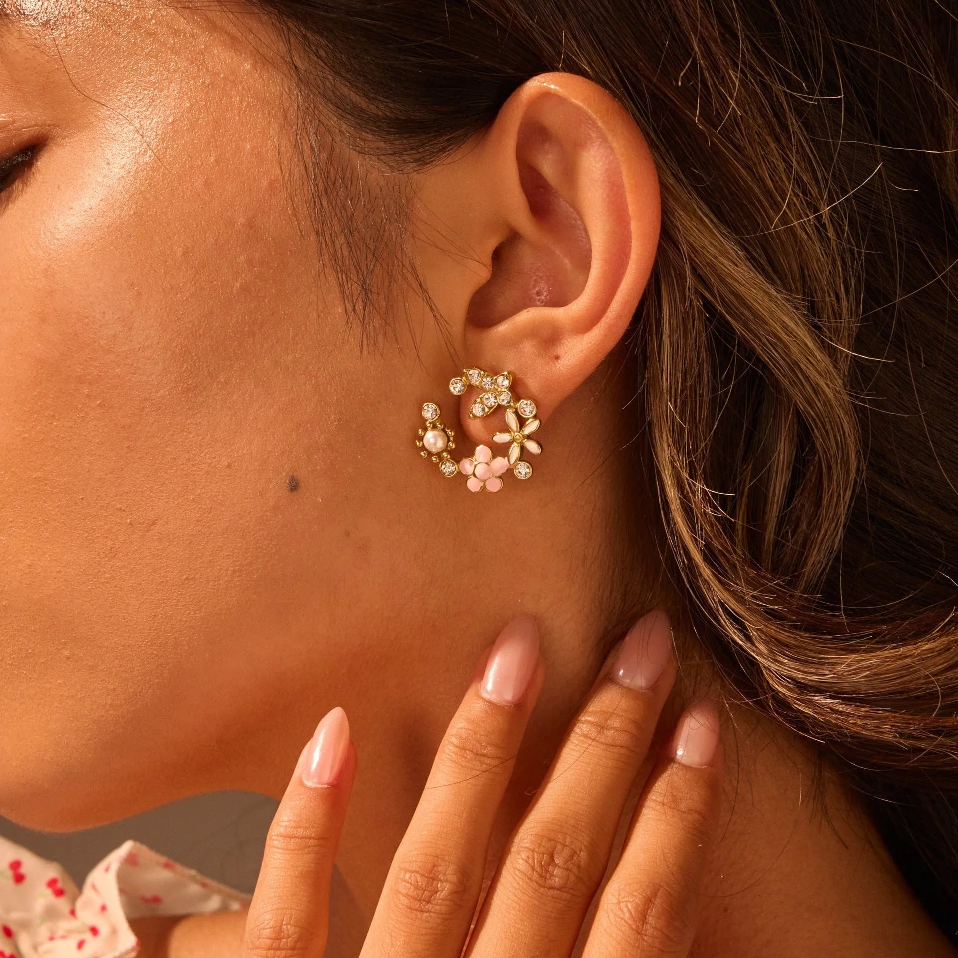 Stainless steel flower stud earrings with colourful oil petals on a white background.