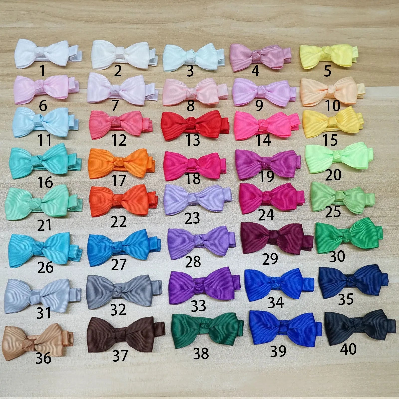 Assortment of pastel coloured fully lined hair clips and bows for babies and toddlers.