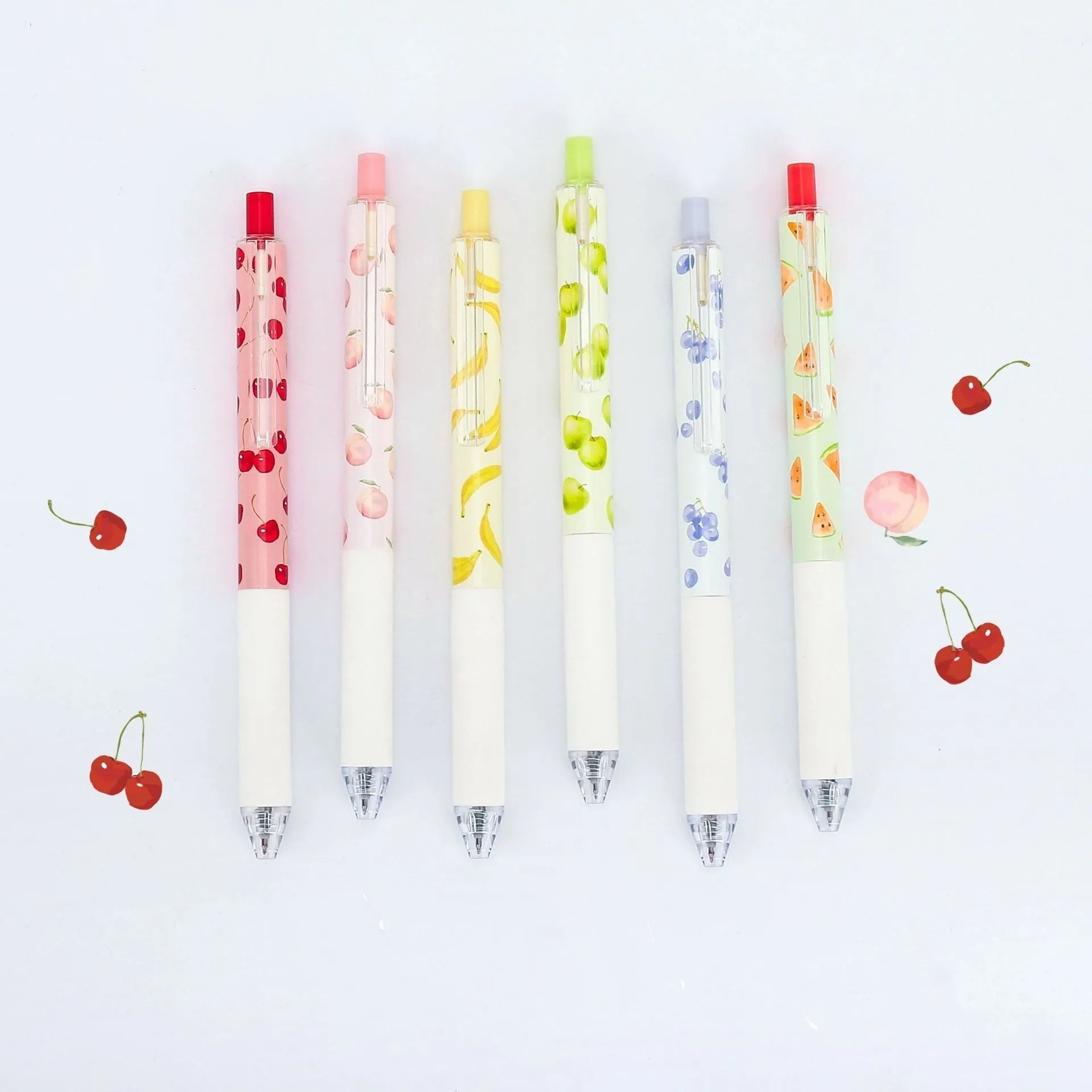 Three scented fruit pens with 0.5mm black ink and press mechanism on white background