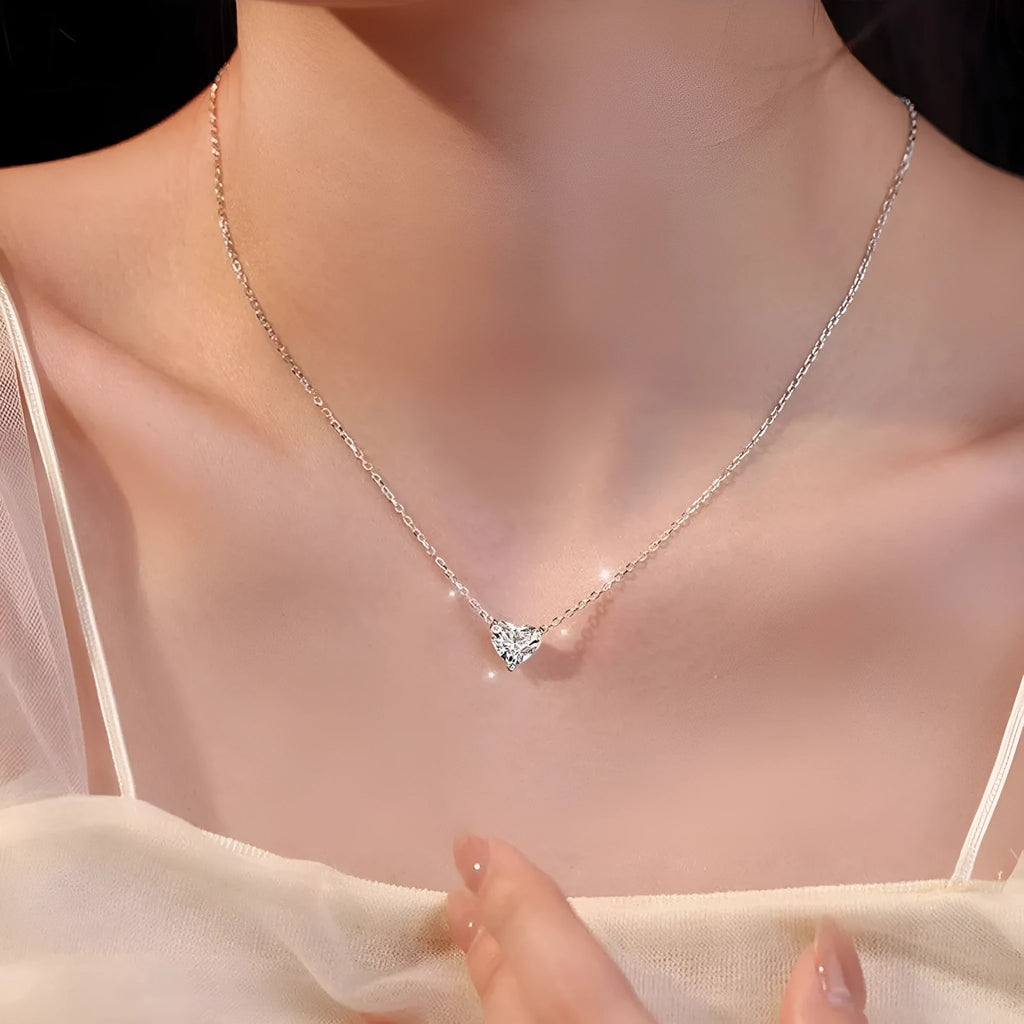 Silver women's heart necklace with simple refined design on copper chain