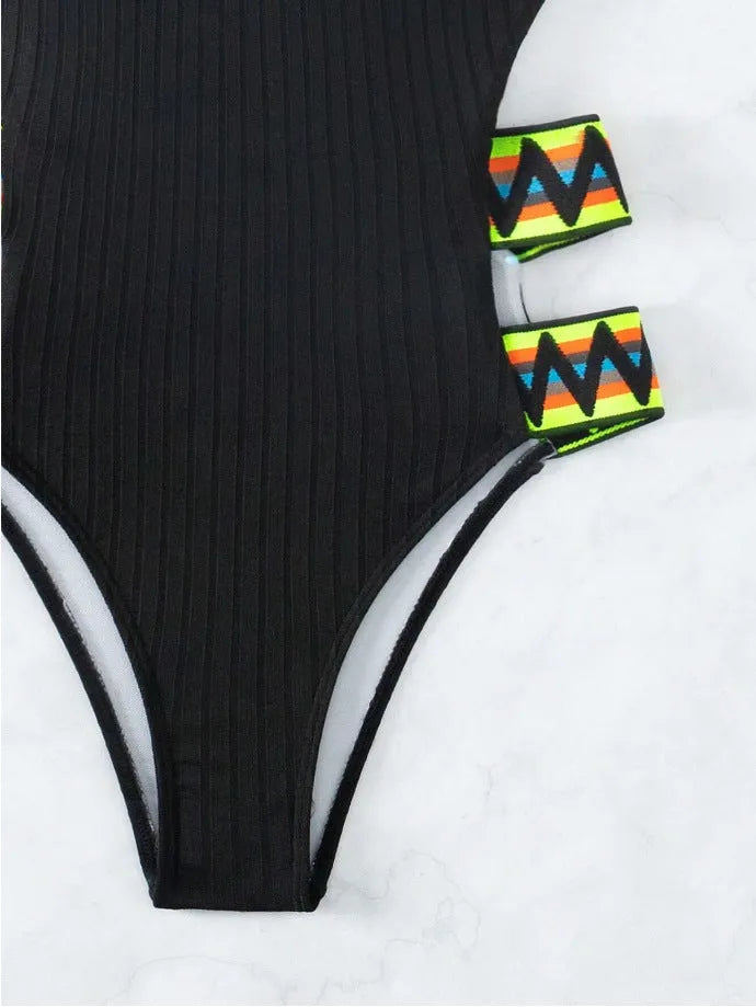 Solid colour women's one-piece bikini swimsuit in black or orange.
