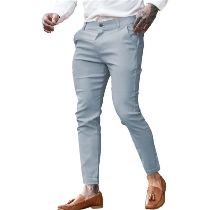 Men's slim fit stretch cotton twill pencil trousers on a hanger, shown in apricot colour.