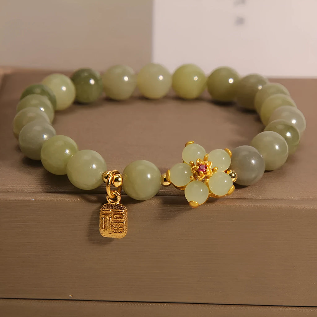 A grey jade and alloy casual bracelet for women, showing its unique design.