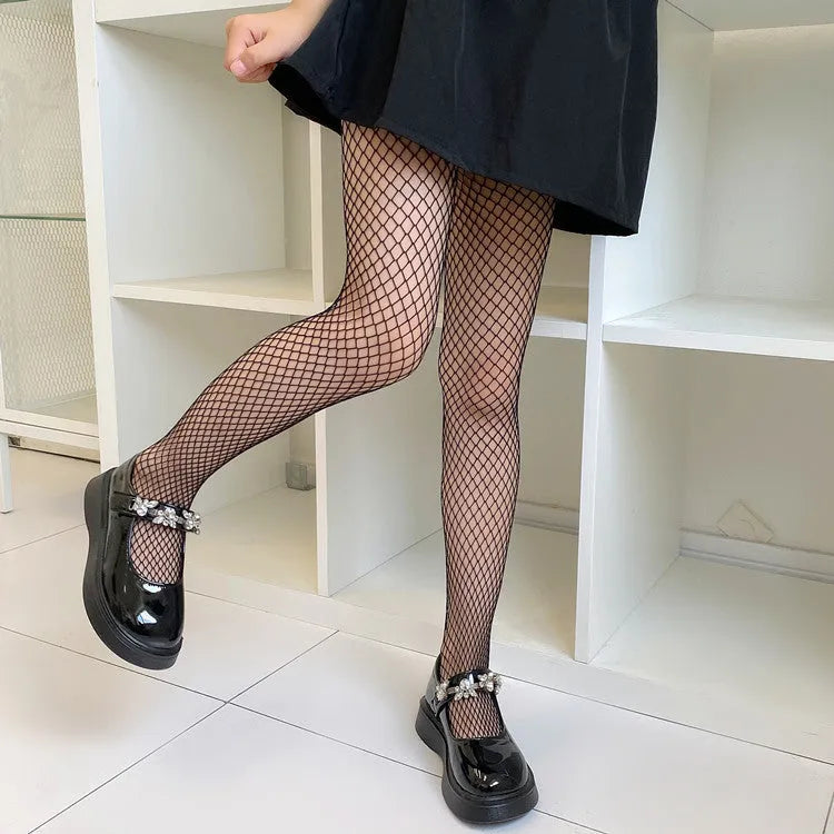 Women's black and white mesh pantyhose showing large, medium, and small fishnet patterns on leg