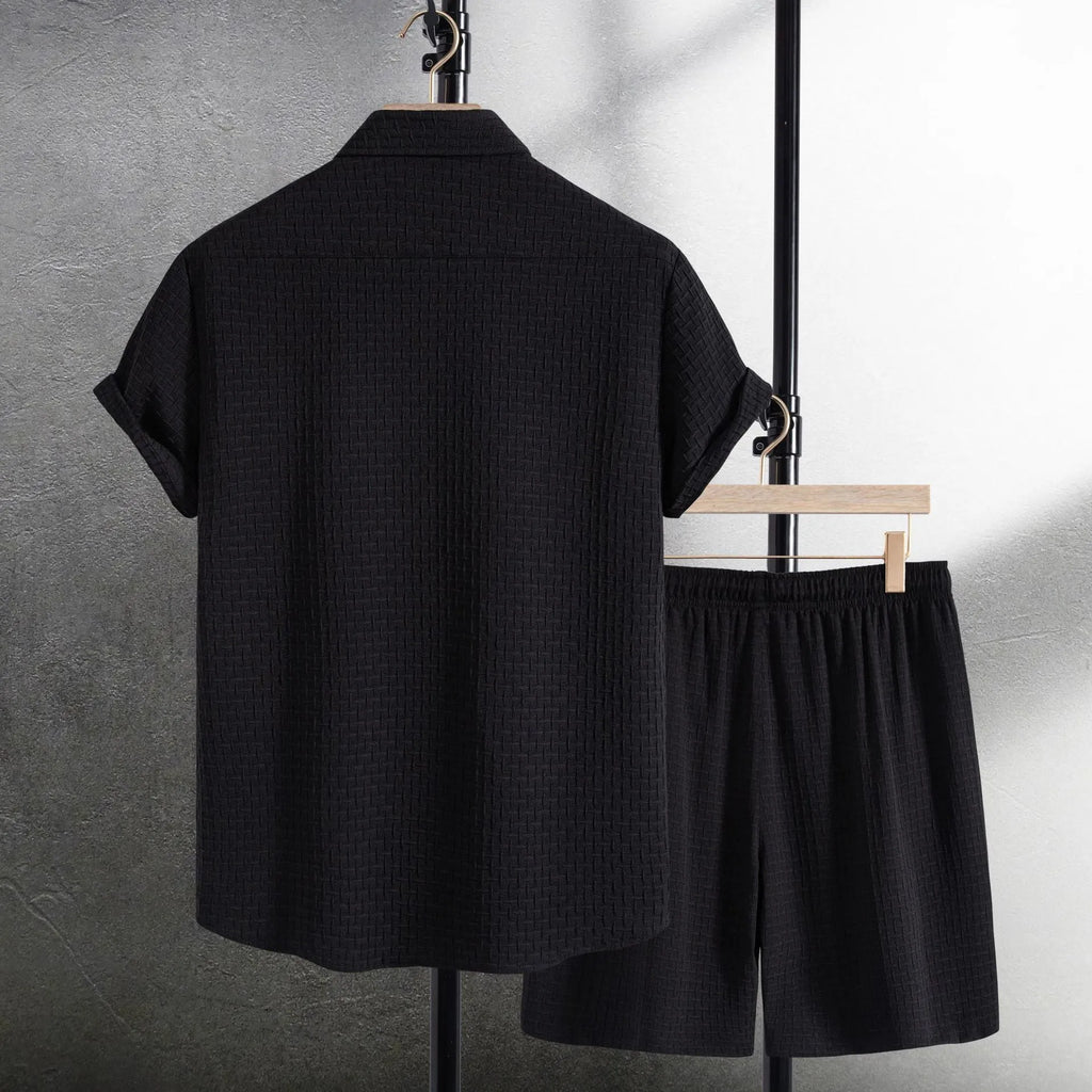 Men's loose-fit cotton blend shirt and shorts co-ord set in solid black colour.