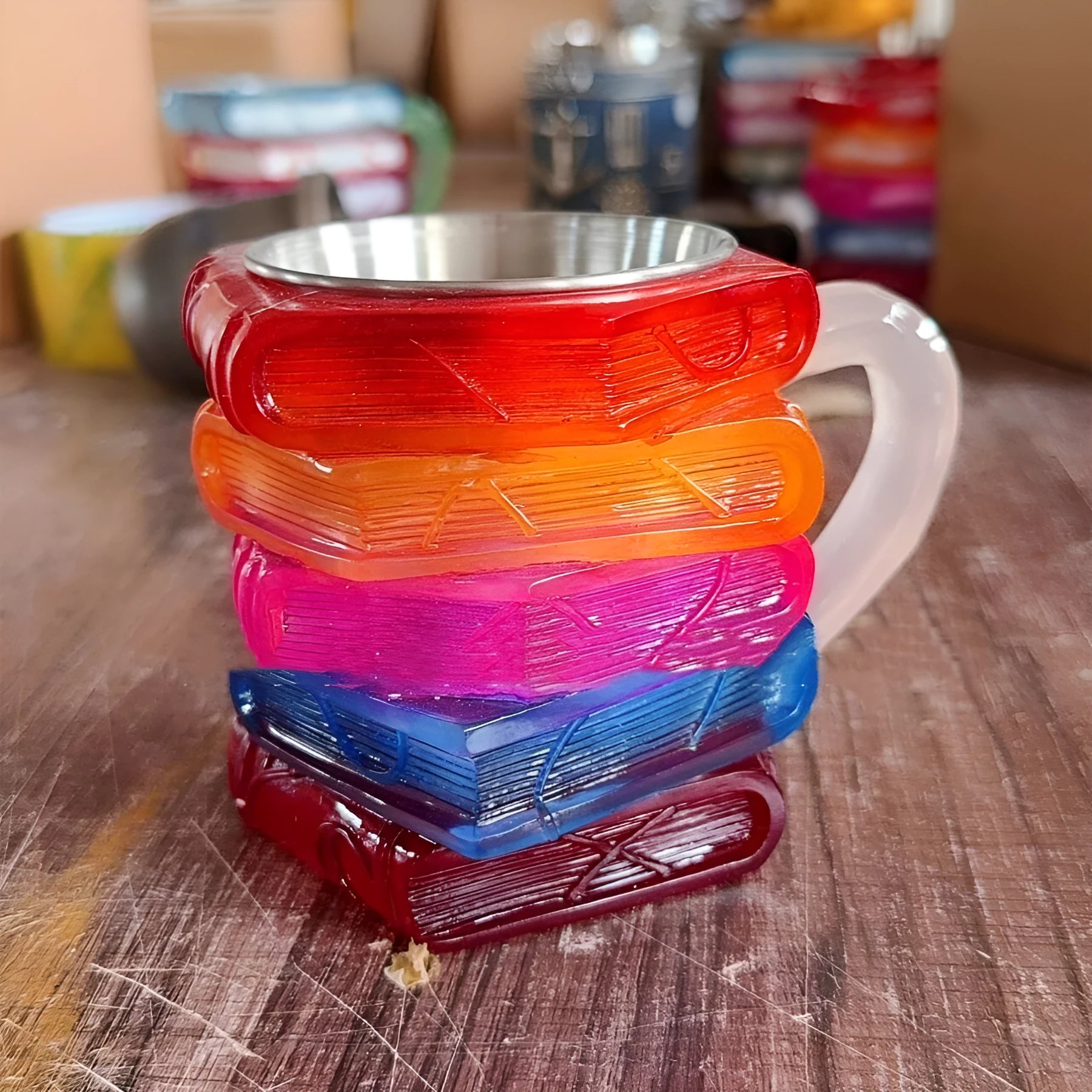 Painted book mark design on a white synthetic resin coffee cup ornament.