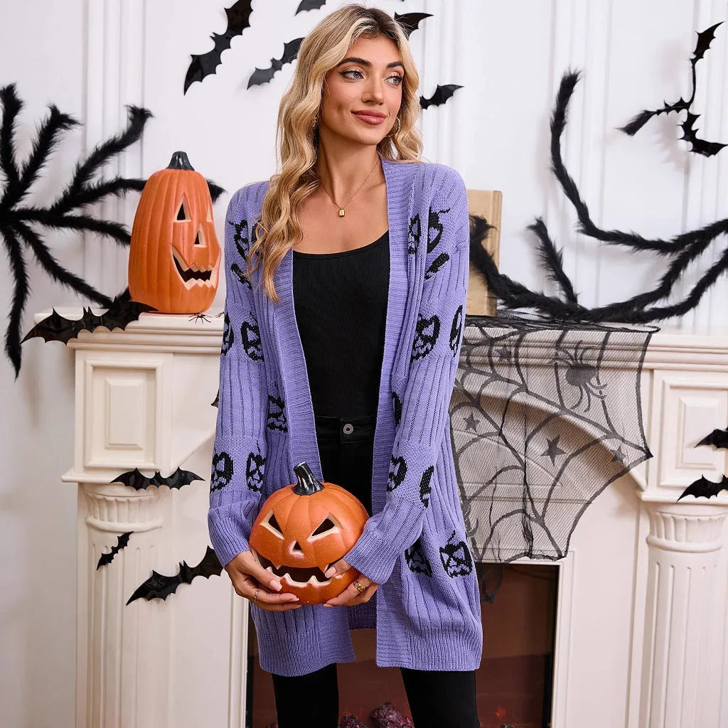 Women's black Halloween cardigan with orange pumpkin head jacquard knit pattern, shown open.