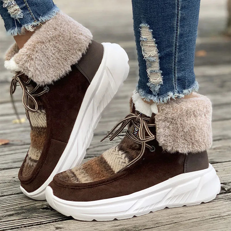 Women's beige lace-up snow boots with suede upper and fur lining on a white background.