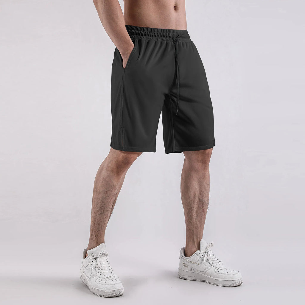 Man wearing loose-fitting black quick-dry mesh shorts with an elasticated waist.