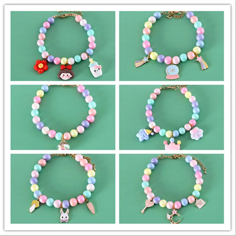Macaron-coloured resin pet collar headdress with moon, meteor, and crown decorations on a small dog
