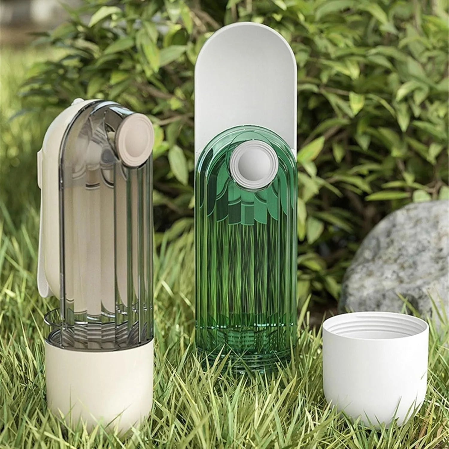 Beige and green foldable dog water bottle with food container, shown with press-to-dispense tray.