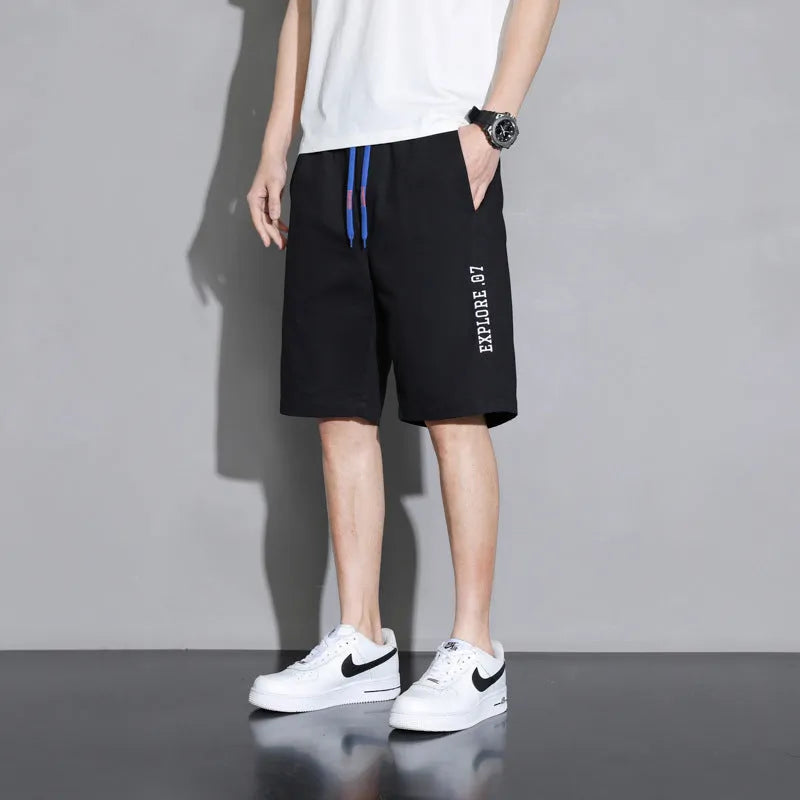 Boys' black cotton shorts in a plus size on a hanger