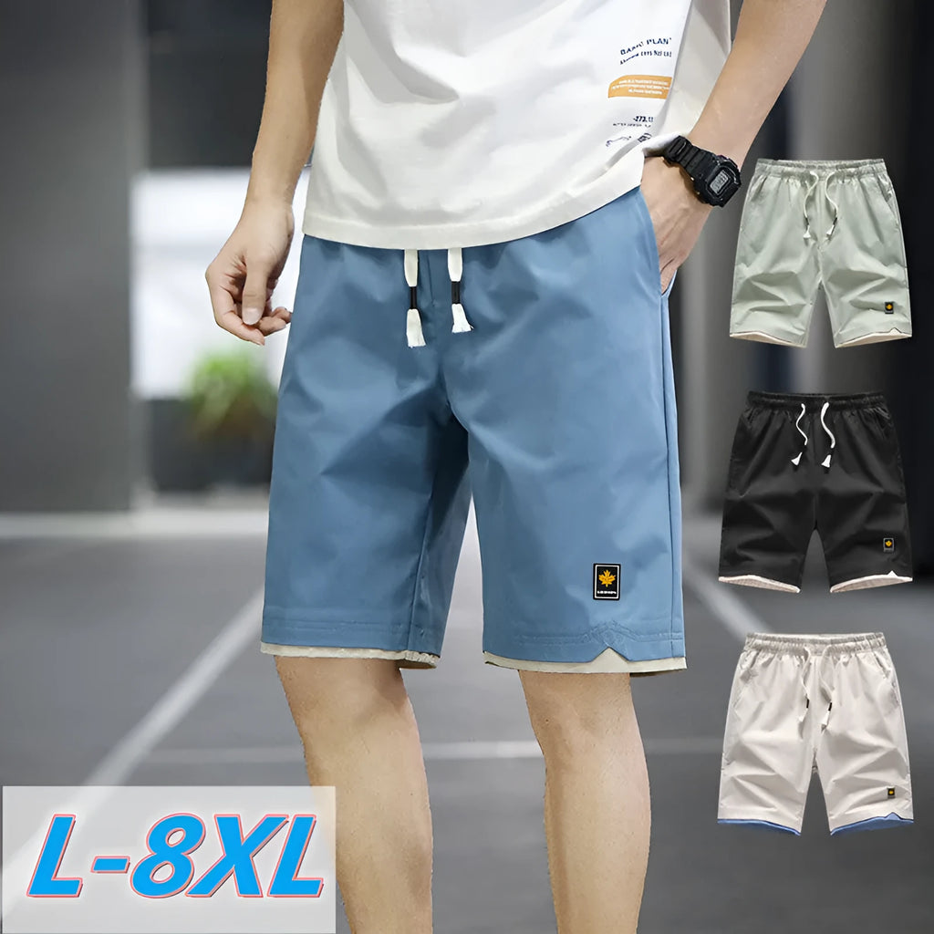 Loose fit casual shorts in green, shown on a model, featuring a straight leg and elasticated waist.