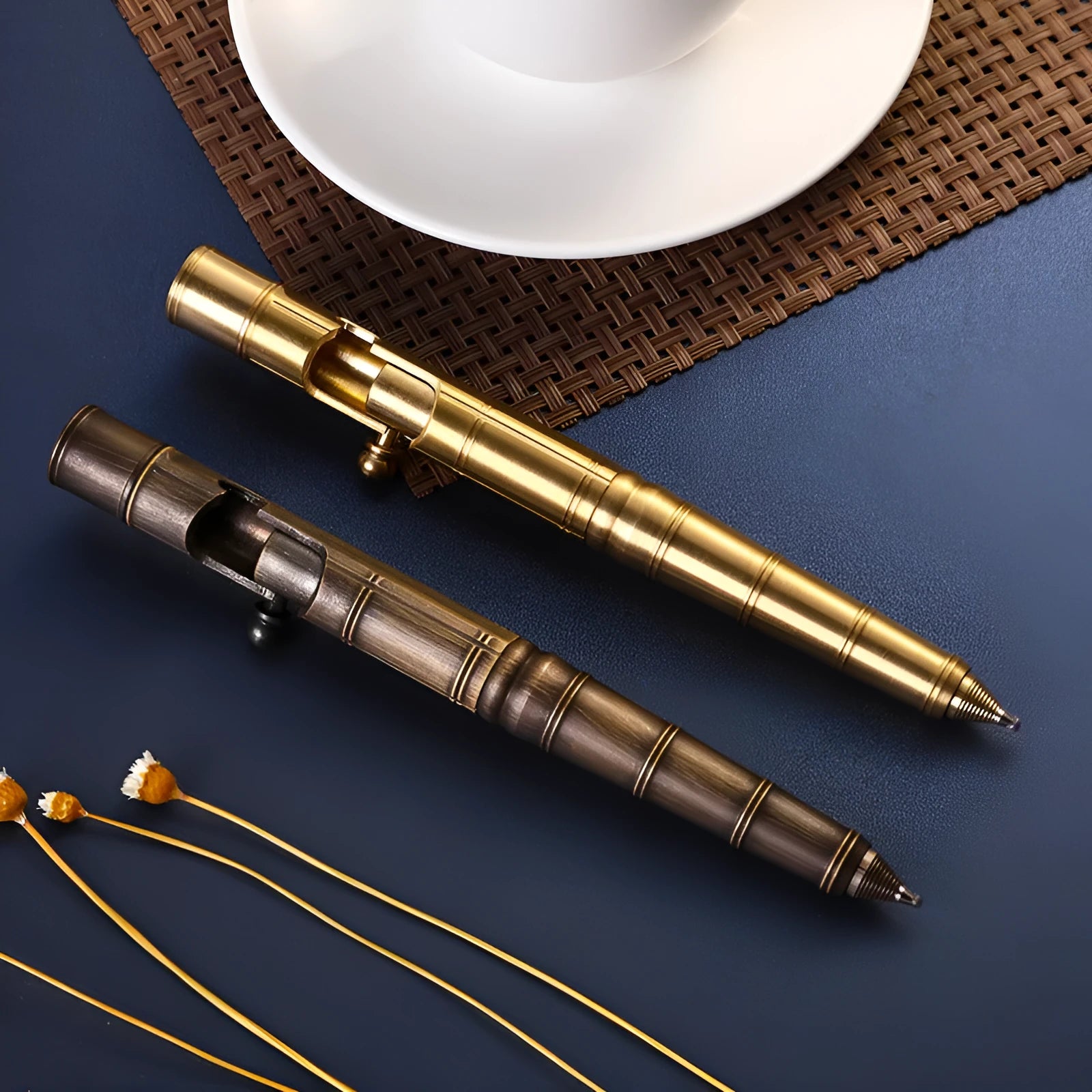 A retro-style brass tactical pen with a bolt-type metal design and press mechanism.