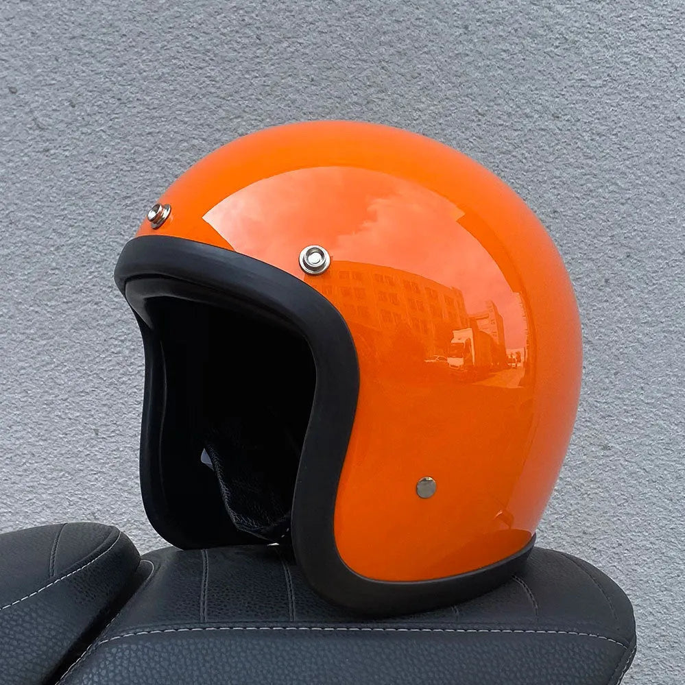 A retro-style motorcycle half helmet made from grey fibreglass, shown from the side.