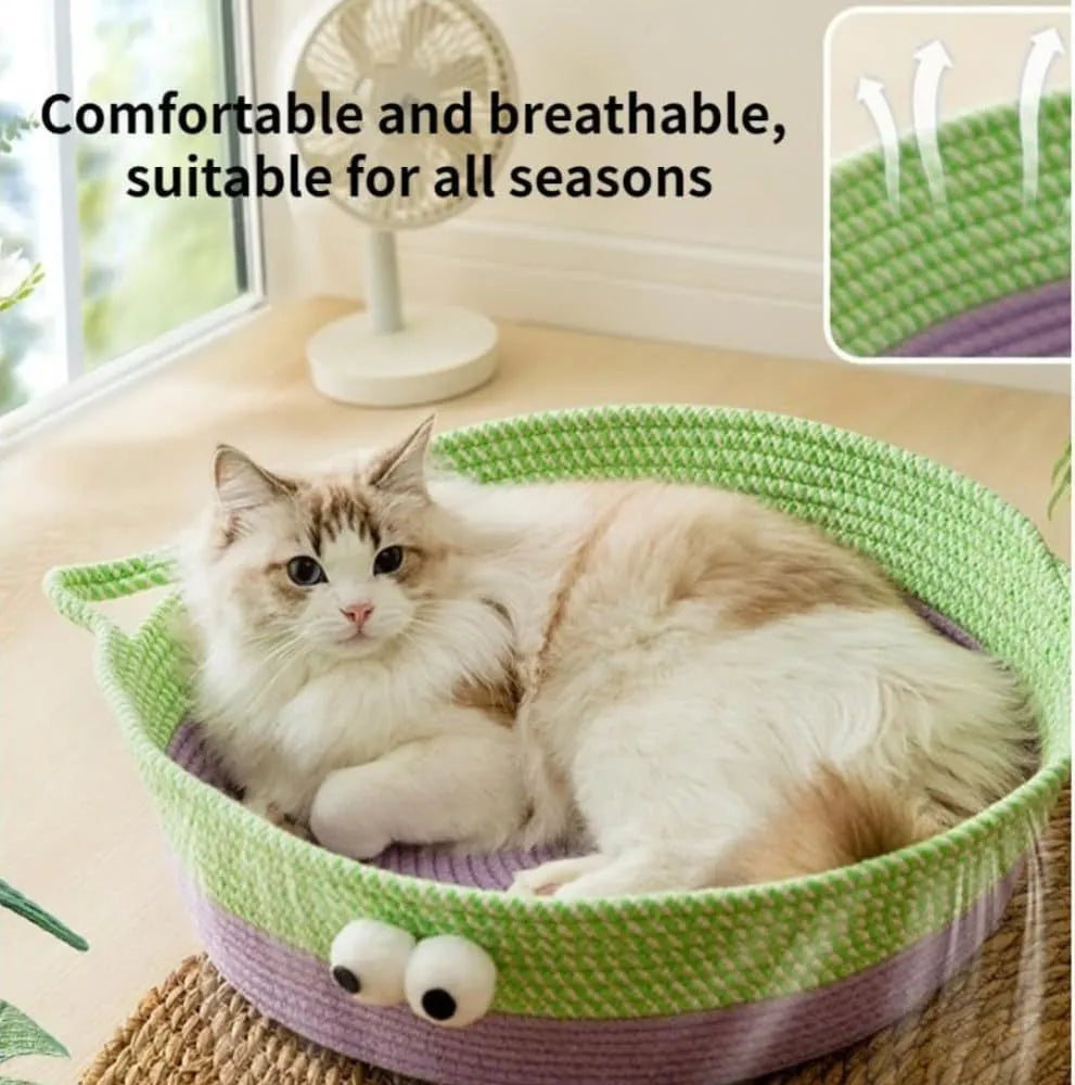 Round woven natural cotton rope cat bed in green with spiral edge, size M, on wooden floor