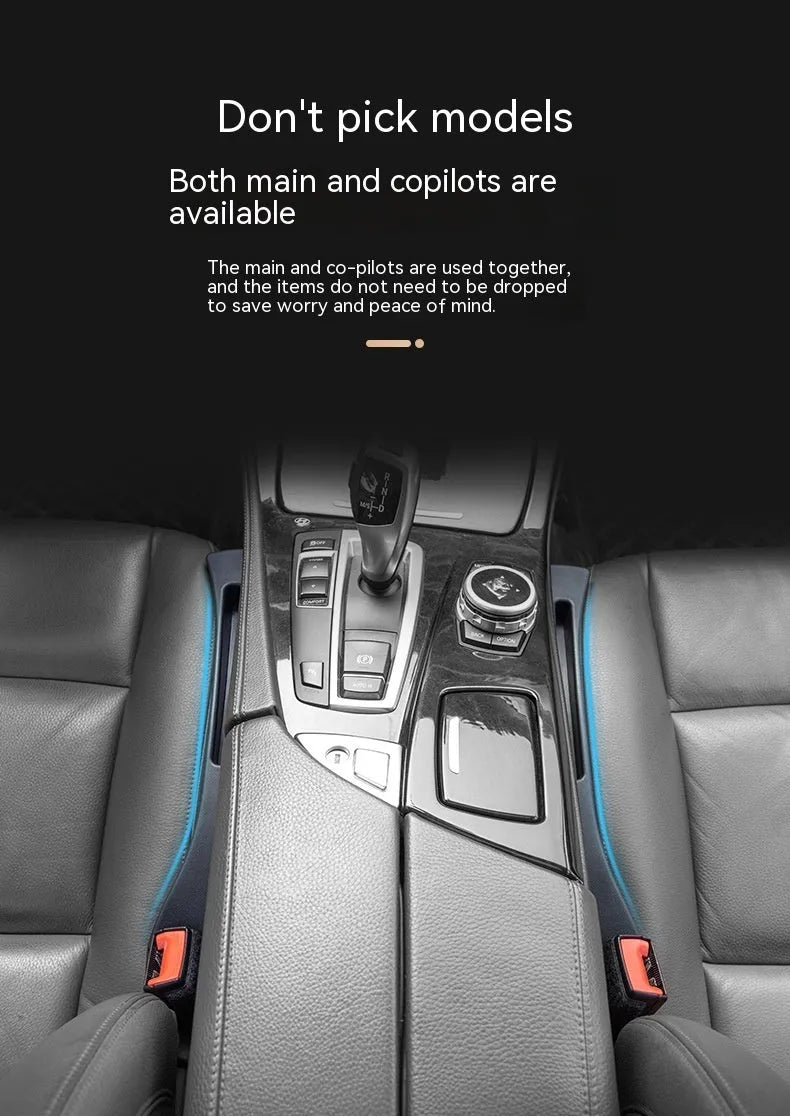 Black plastic car seat gap storage box with handle positioned between vehicle seats