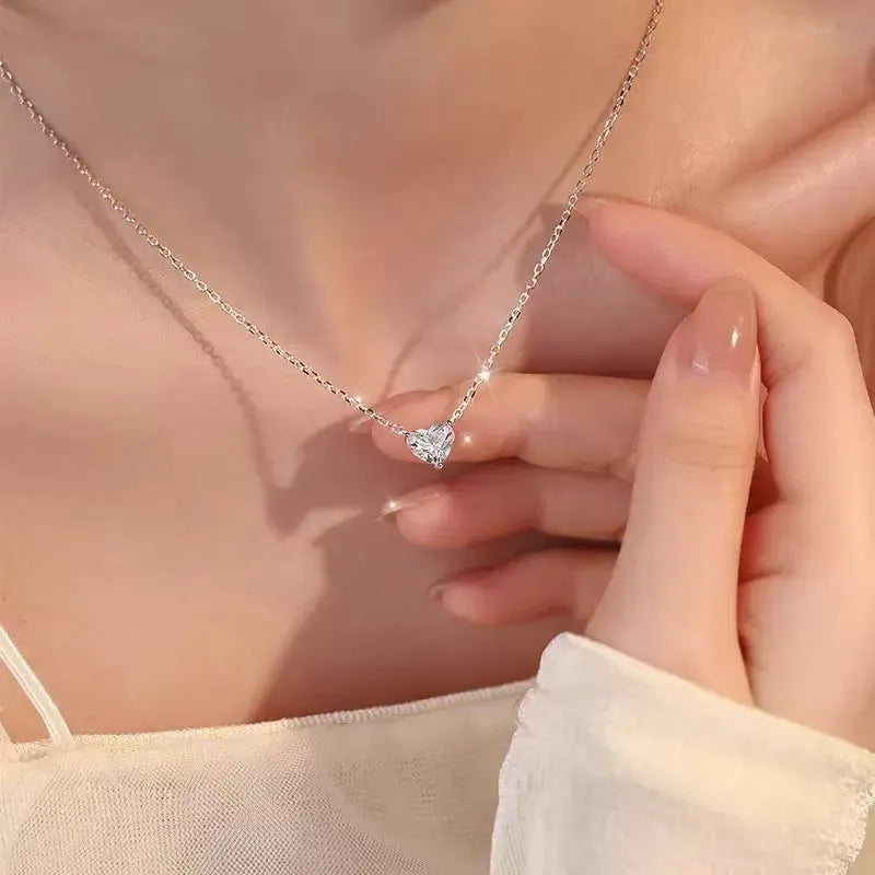 Silver women's heart necklace with simple refined design on copper chain