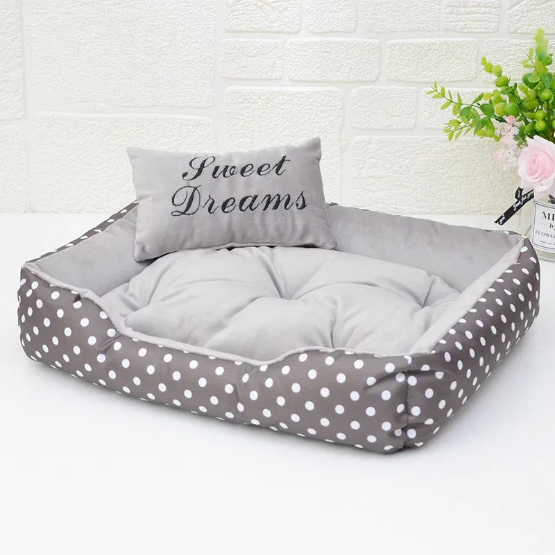 Printed polka dot square nest dog bed with matching pillow in grey, blue, pink, or red.