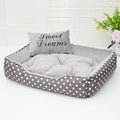 Printed polka dot square nest dog bed with matching pillow in grey, blue, pink, or red.