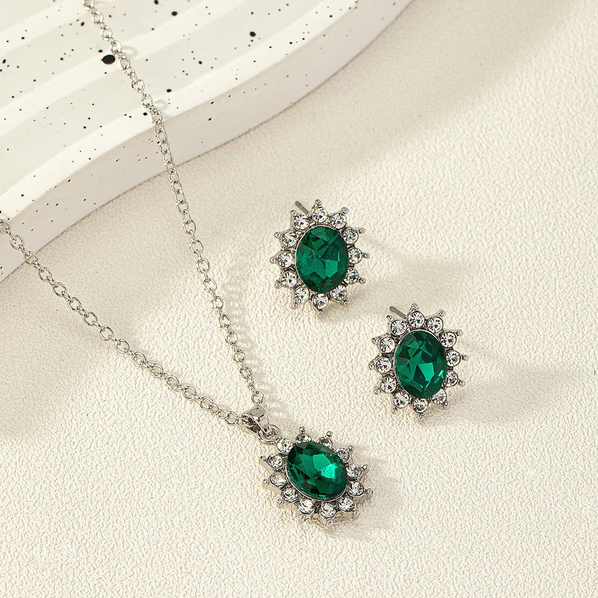SUNFLOWER women's alloy ear stud and necklace set in simple ellipse design on a white background.