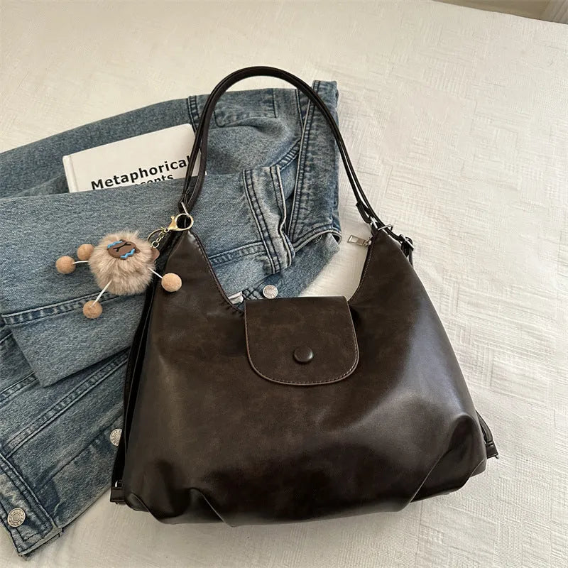Textured PU leather commuter backpack with single shoulder strap and internal mobile phone pocket
