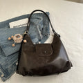 Textured PU leather commuter backpack with single shoulder strap and internal mobile phone pocket