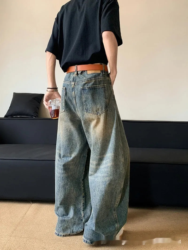 Men's retro blue distressed denim jeans with a wide-leg slim fit and micro elasticity.