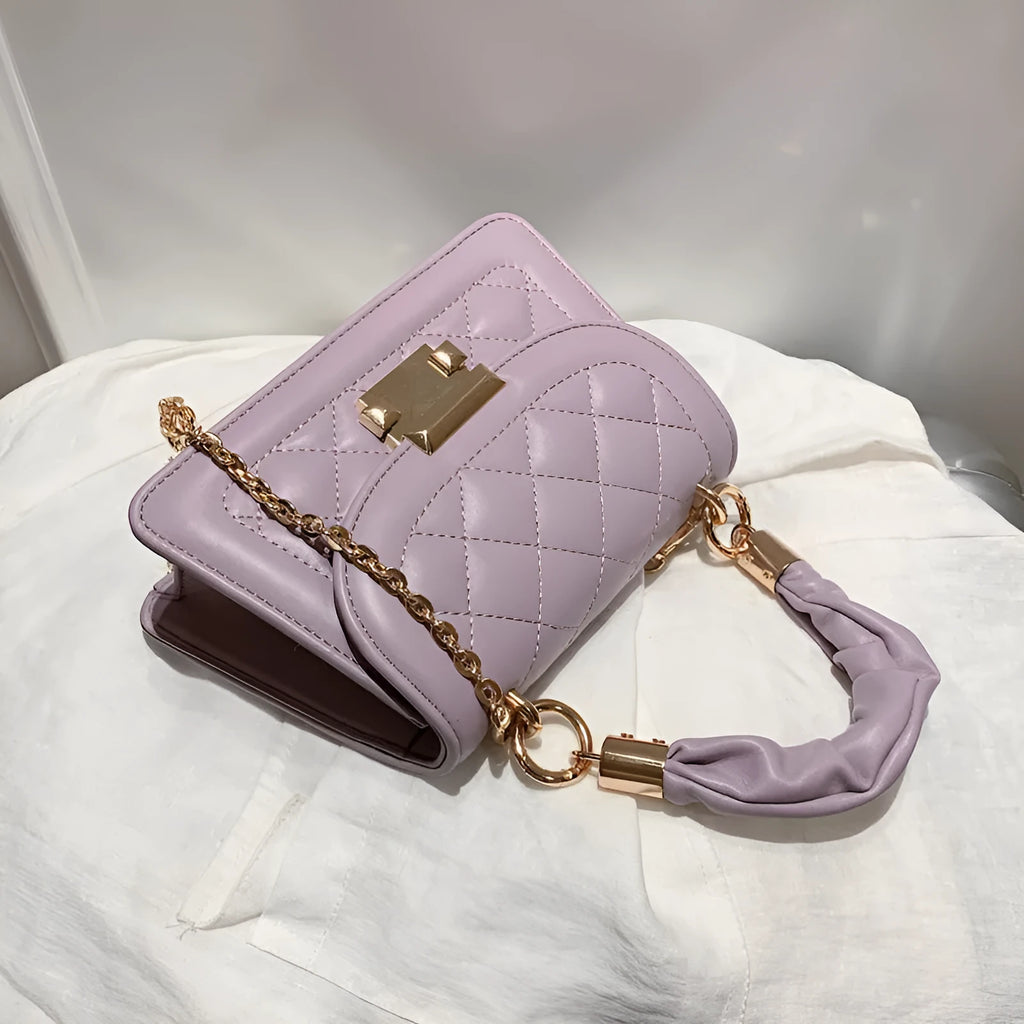 Purple rhombus-shaped women's shoulder bag with crossbody strap on mannequin