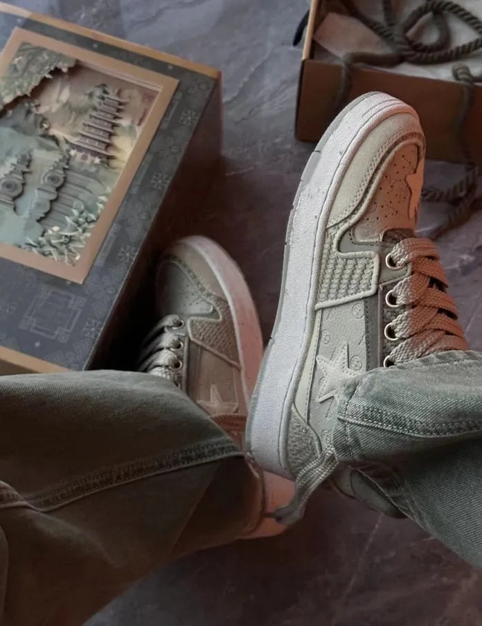 Green low-top canvas casual shoes with star pattern and white stitching on a rubber sole.