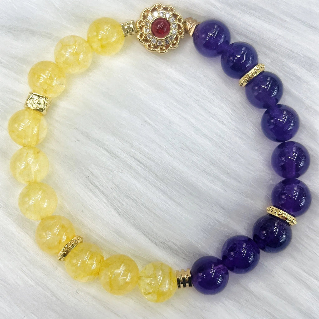 Handmade yellow and purple crystal bracelet for women on a wrist.