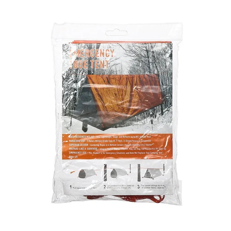 Portable orange disaster relief tent with sleeping bag and emergency blanket setup outdoors